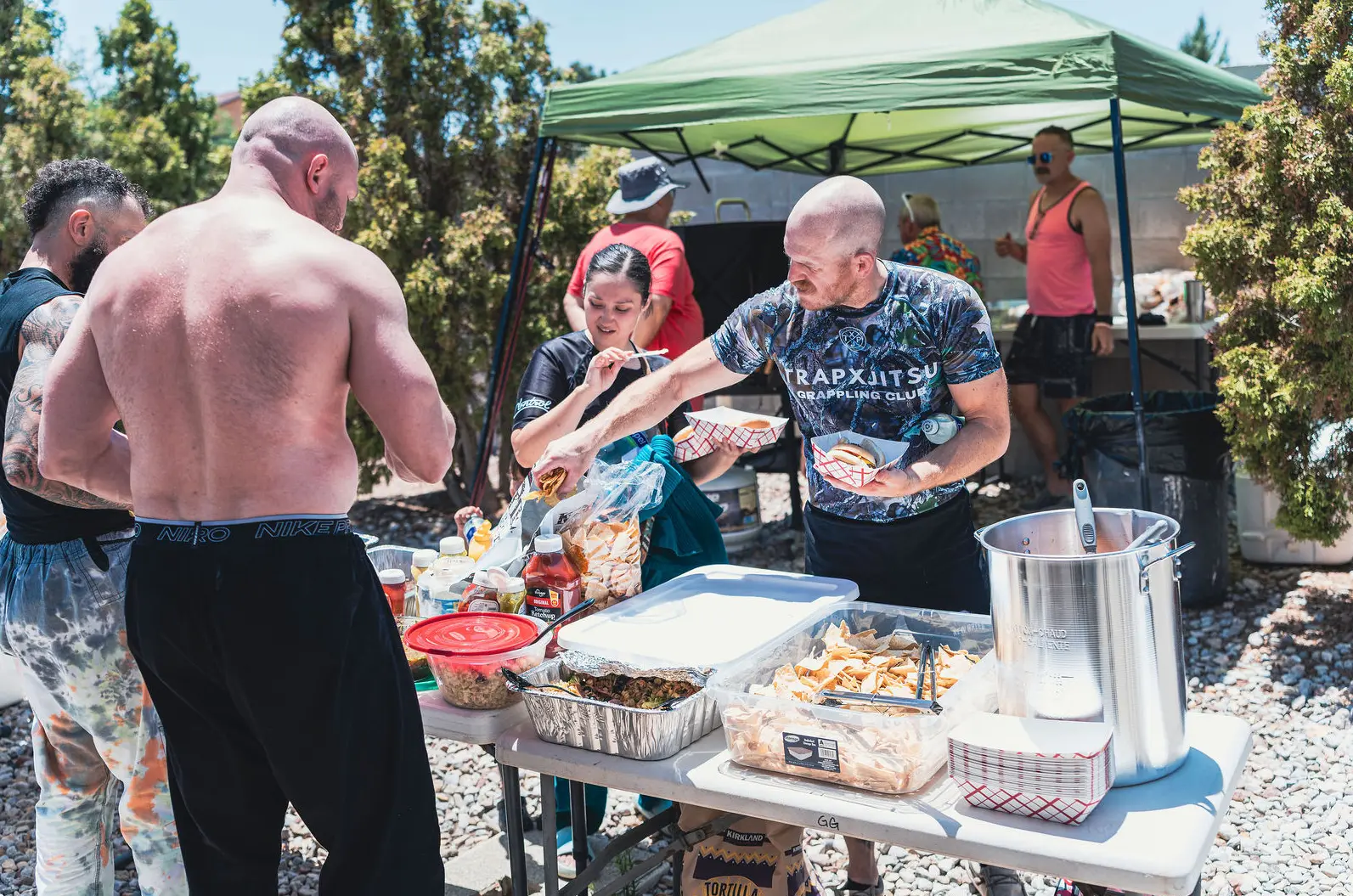 Grounded Strength Academy members gathered around a table at a community cookout